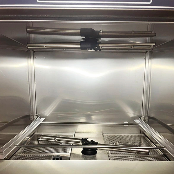 V-TAI Undercounter Dishwasher Interior - 304 Stainless Steel & Efficient Spray System Internal view of V-TAI undercounter dishwasher showing 304 stainless steel interior, spray arms, and filter screen.