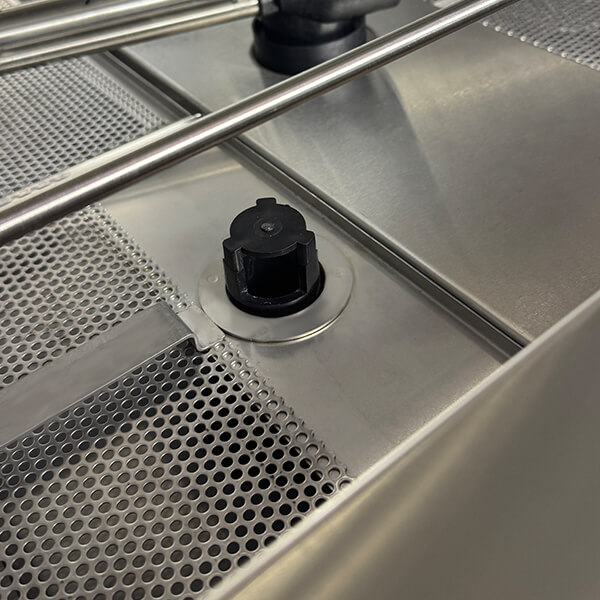 V-TAI Undercounter Glass Washer Interior - Durable 304 Stainless Steel & Filtration Internal bottom view of V-TAI undercounter glass washer, 304 stainless steel interior with robust filter screen.